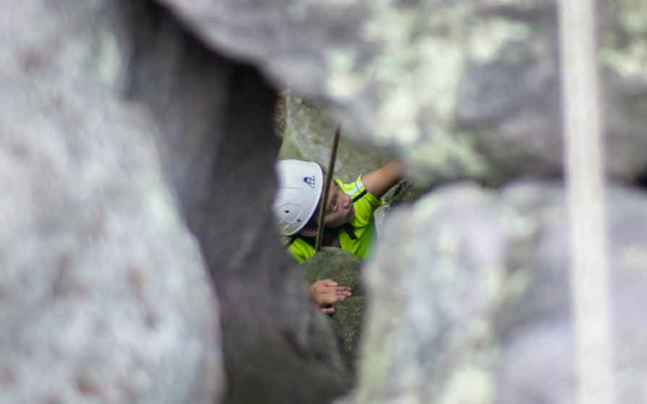 girl navigates route while rock climbing